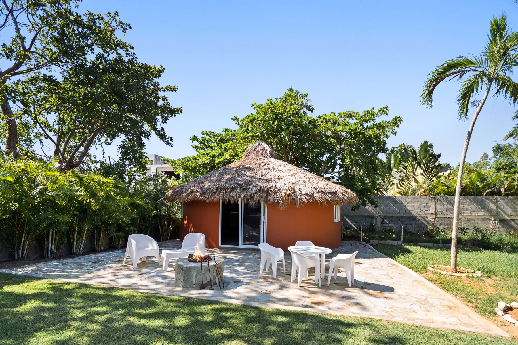 Shaded outdoor dining pavilion in the tropical garden